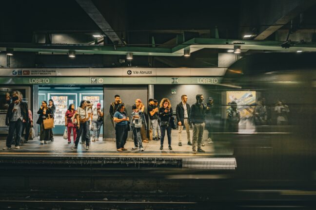Commuters waiting on a metro platform at Loreto station in Milan