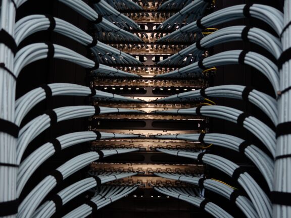 Close-up of network cables and patch panels in a server rack