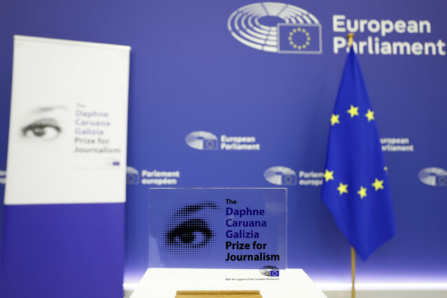 Daphne Caruana Galizia Prize for Journalism display with an EU flag and European Parliament logo in the background