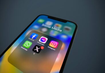 Smartphone screen showing a Social Media folder with Facebook, Messenger, Instagram, WhatsApp, and X apps