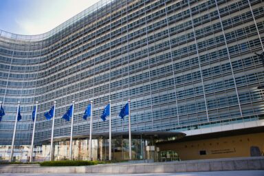 Berlaymont building, the European Commission headquarters in Brussels, with a row of EU flags in front