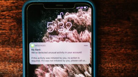 A smartphone displaying a warning message from a bank
