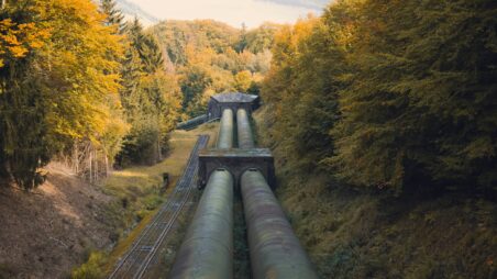 A gas pipeline running through an autumn forest